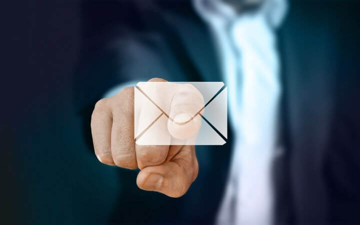 A finger pointing at an email icon